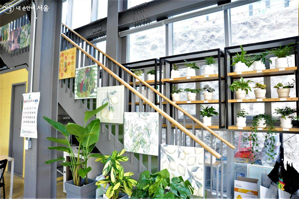 2층으로 오르는 계단을 중심으로 미술작품과 식물들로 플랜테리어를 선보이고 있다. ⓒ조수봉