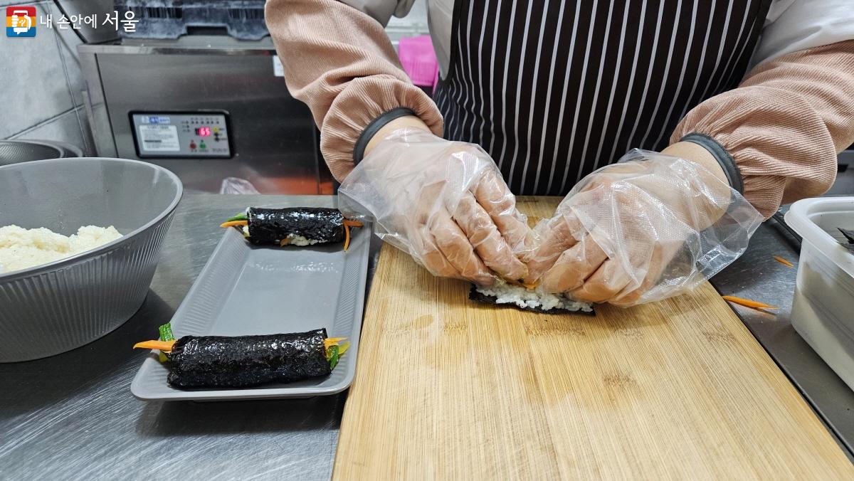 오후에 선보이는 꼬마김밥 메뉴를 위해 어르신이 정성스레 김밥을 말고 있다. ©이선미 