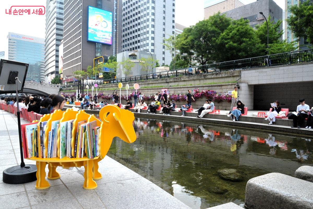 청계천에 마련된 '책읽는 맑은냇가' 서울야외도서관을 찾은 시민들이 독서하며 휴식하고 있다. ©이봉덕