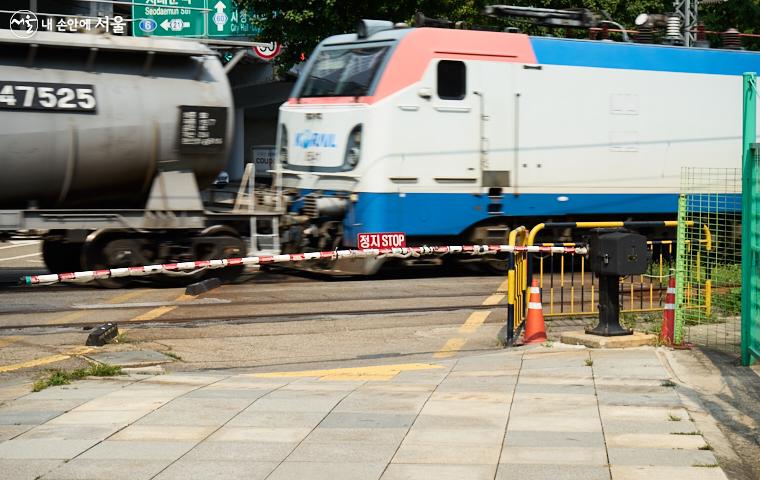 서소문 철도건널목의 차단기 너머에 기차가 지나가고 있다 ⓒ이정규