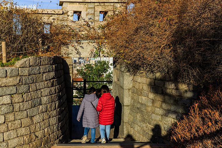 낙산에는 3개의 암문이 있는데 기자와 함께한 동행인들이 해설사와 함께 또 다른  암문을 통과하고 있는 모습