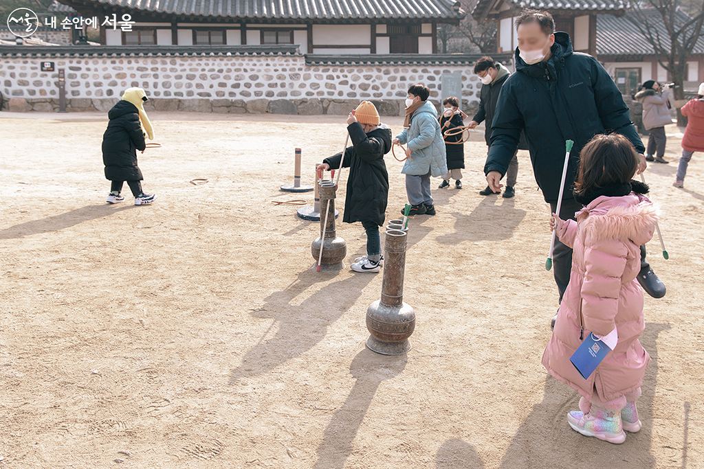 정월대보름을 맞아 남산골한옥마을로 나들이 나온 시민들이 민속놀이 중 하나인 투호놀이를 즐기고 있다 ⓒ문청야