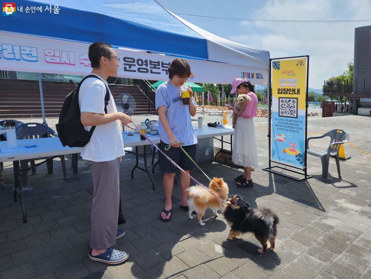 QR코드 작성 후 수영장 입장을 기다리는 보호자와 반려견  ⓒ조시승