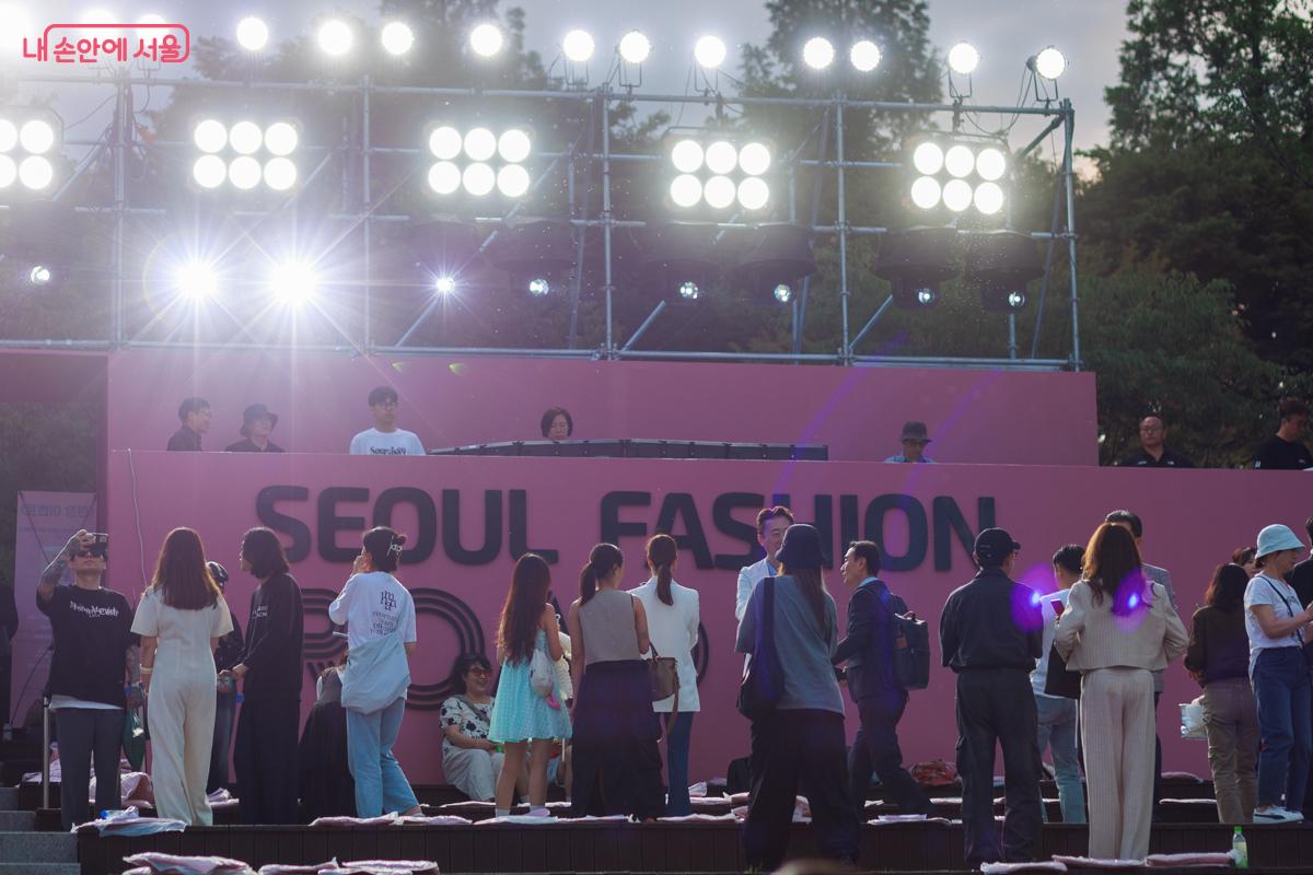 서울패션로드 행사가 끝난 현장. 불빛이 반짝이는 무대를 뒤로 하고 관람객들이 자리를 뜨고 있는 모습 ©유서경