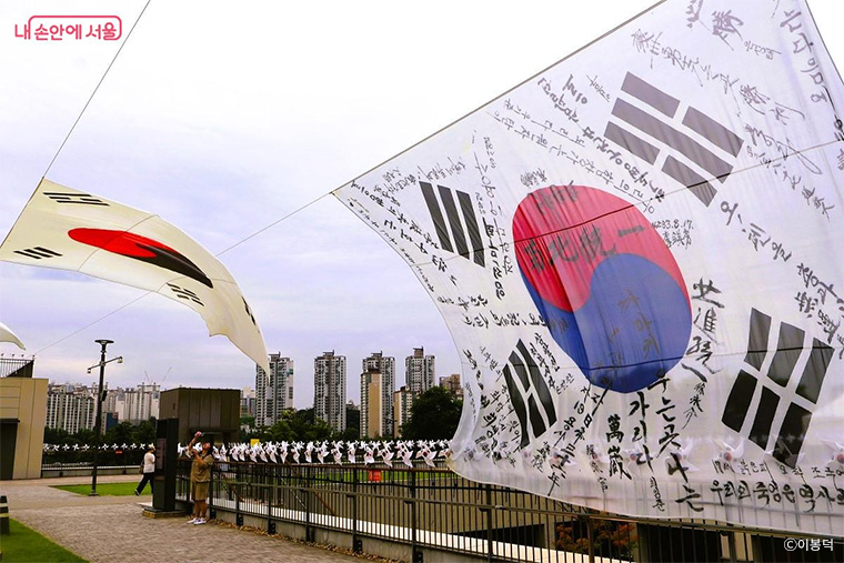 역사의 숨결을 품은 태극기들이 바람에 힘차게 펄럭이고 있다.