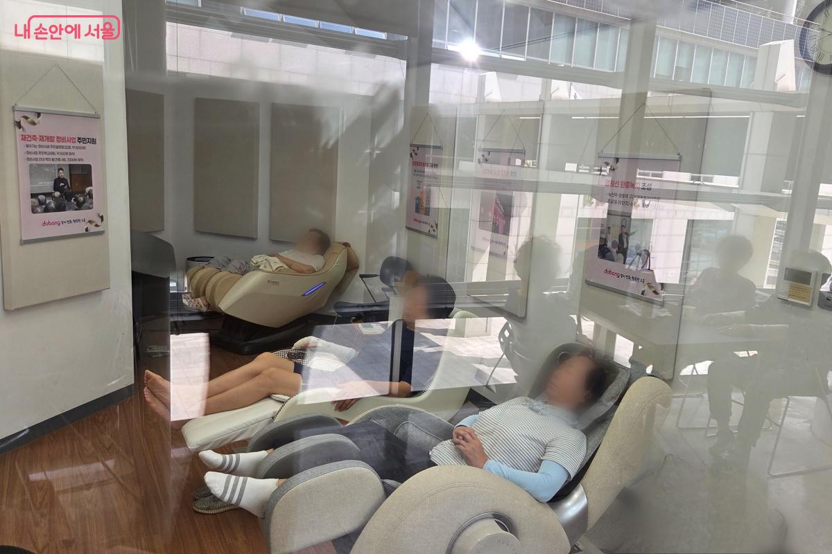 피로를 풀어주는 안마의자를 이용하고 있는 주민들 &copy;김미선