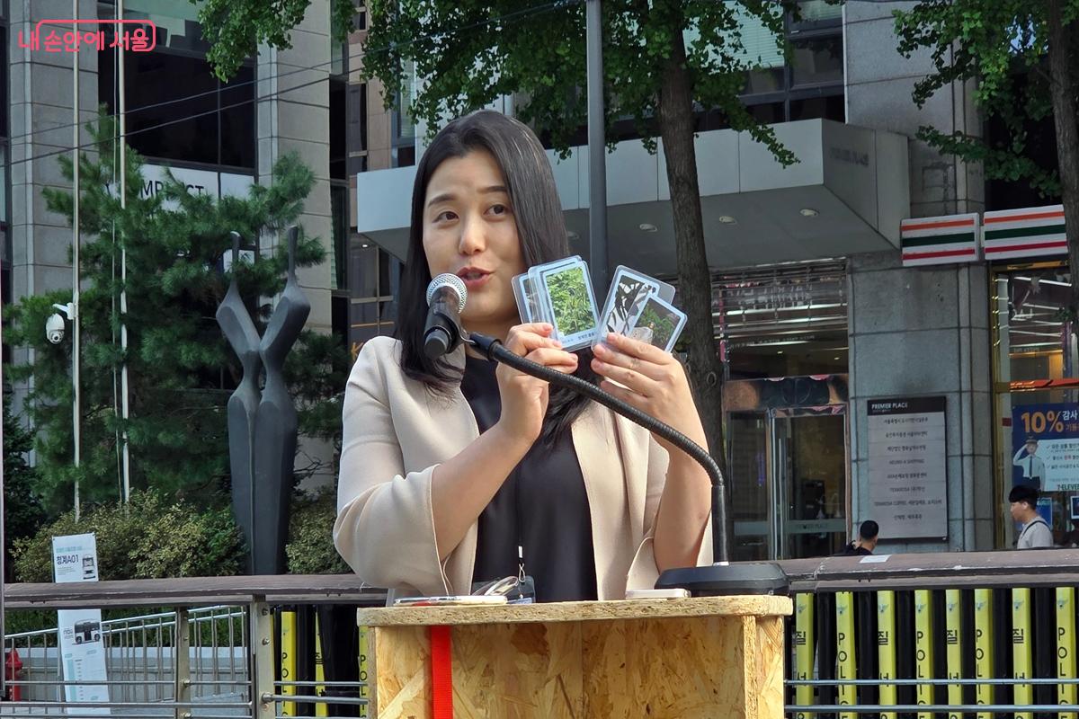 임정민 작가가 청계천 서식 새를 포착해 만든 한정판 포토카드를 보이고 있다. ©김윤경