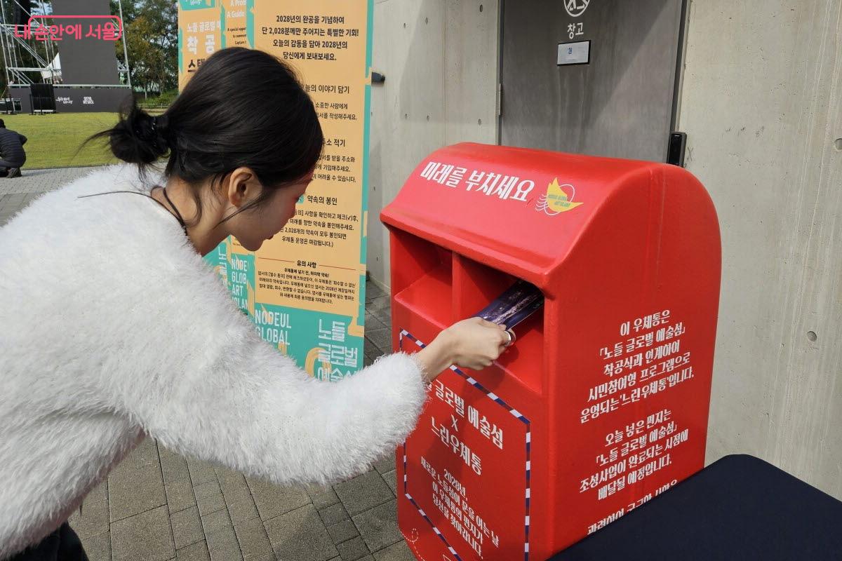 3년 후에 보낼 예정인 그림엽서를 우체통에 넣고 있다. ⓒ이선미