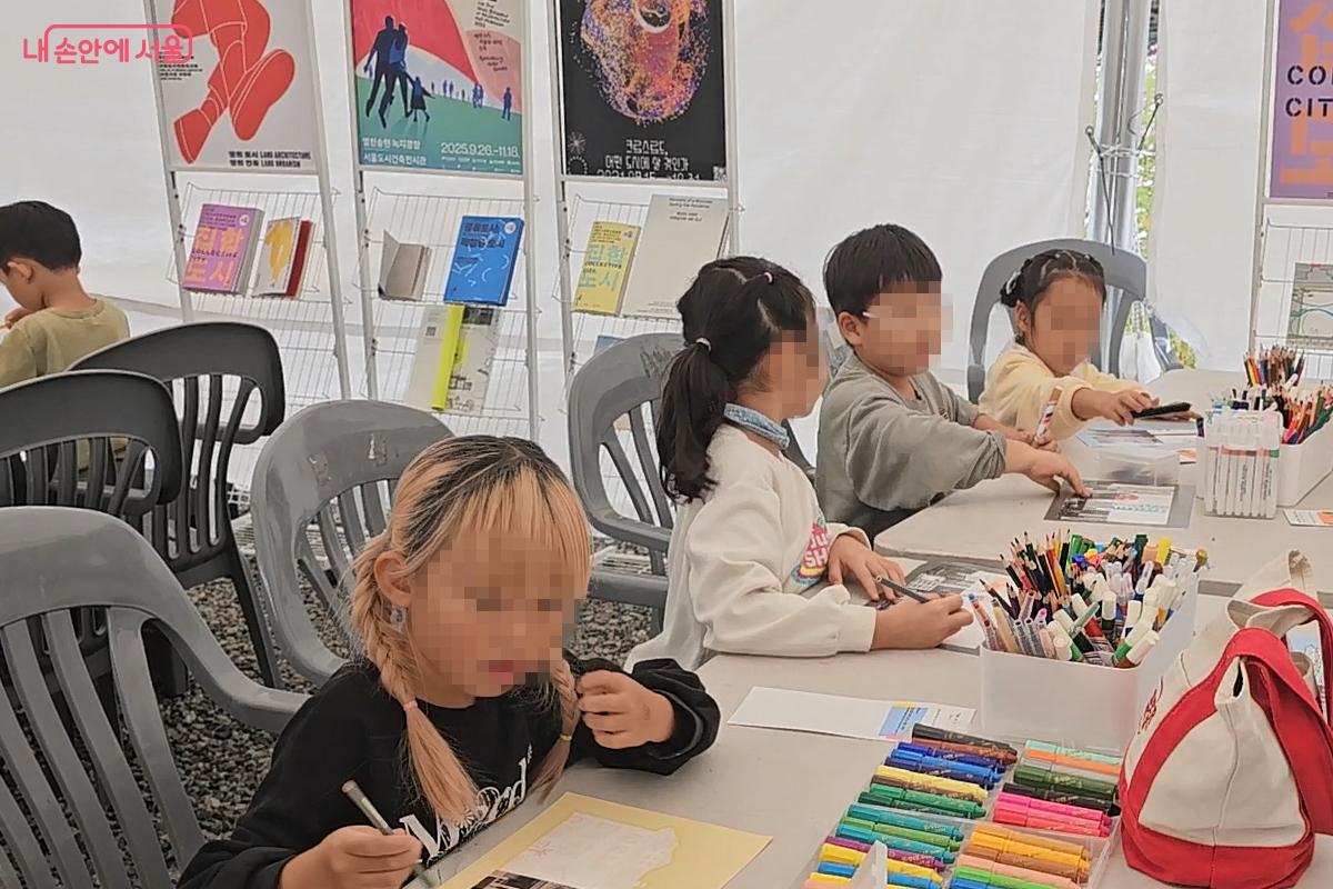 송현열린녹지광장 옆 체험존에서 그림을 완성해보는 어린이들 ⓒ오도연