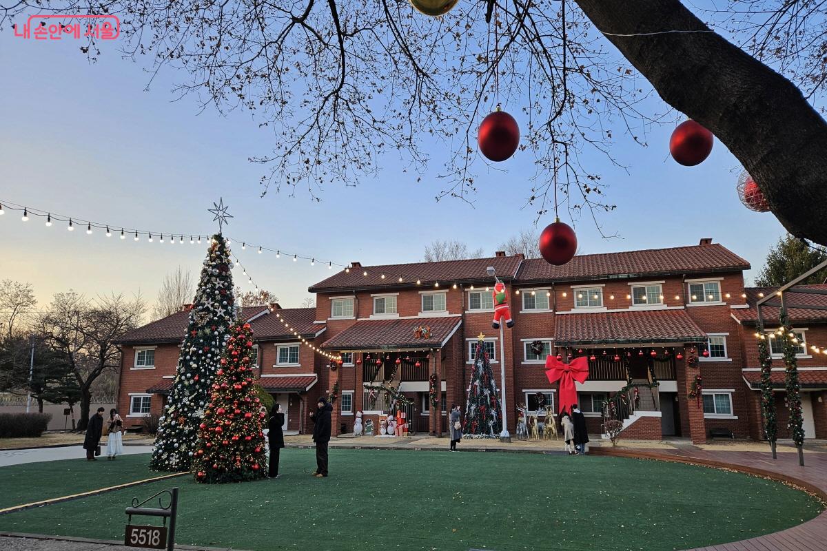 붉은 벽돌 숙소들이 둘러싼 파빌리온 한가운데 크리스마스 트리가 있다. ©이선미