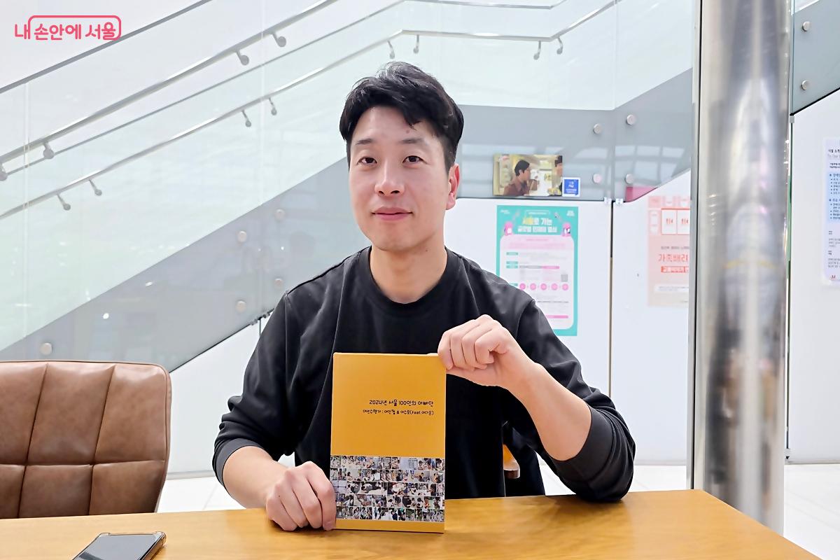 지난해 서울시 아빠단 단장으로 활동한 이인철 씨. 직접 만든 활동 사진집을 보여주고 있다. &copy;김윤경