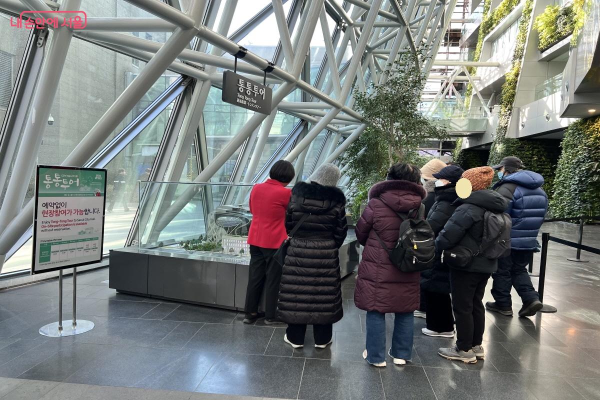 빨간 옷을 입은 전문해설사의 이야기를 듣고 있는 참여자들 ⓒ박지영