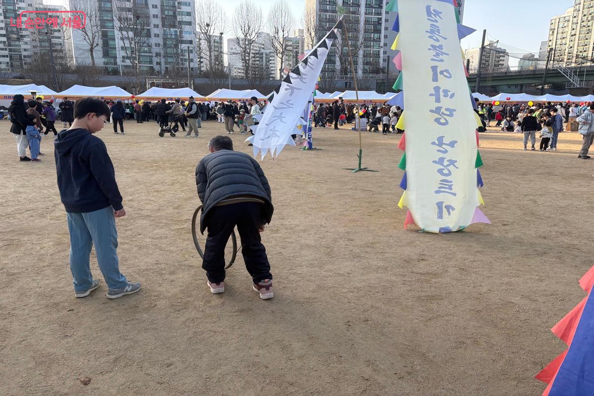 할아버지가 손자에게 민속놀이를 설명하고 있다. ⓒ조현영