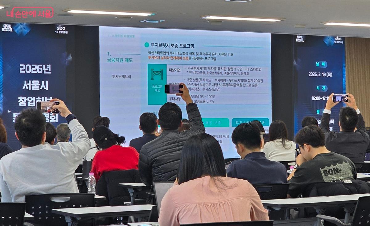 지원사업 설명을 들으며 사진을 열심히 찍는 참가자들 &copy;조성희