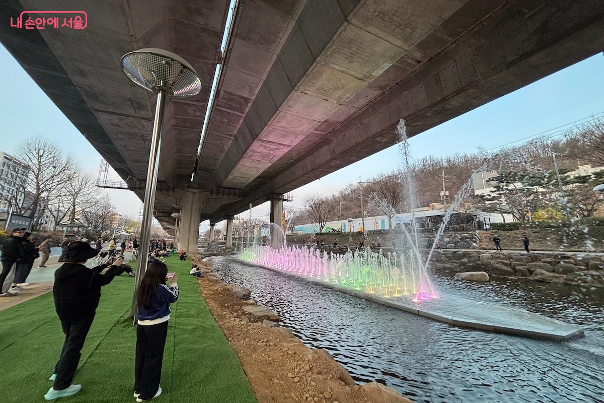 홍제천을 산책하며 음악분수를 감상하는 시민들 &copy;이혜원