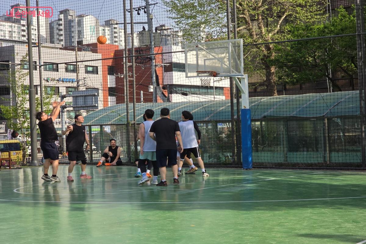 청년들이 한낮의 더위에도 땀 흘리며 농구를 하고 있다. &copy;강사랑