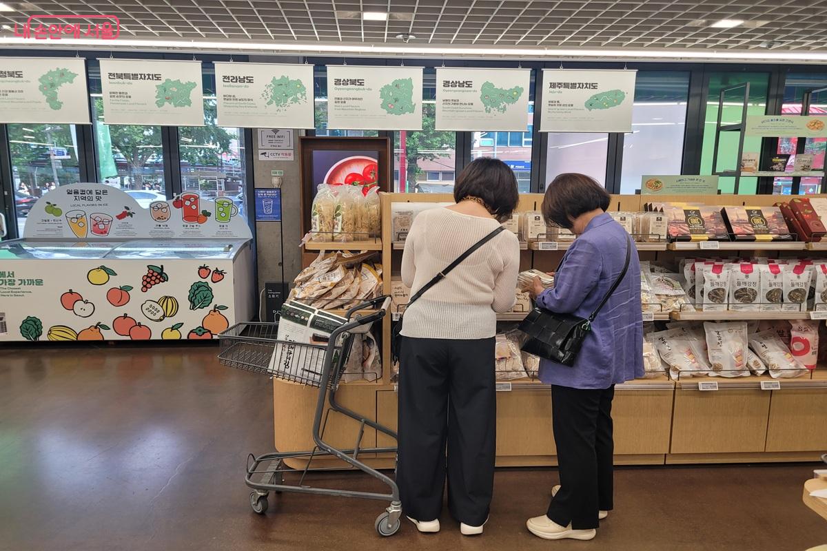 시민들이 상품 정보를 확인하며 지역 특산품을 살펴보고 있다. &copy;조연