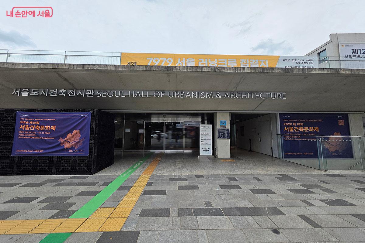 세종대로와 자연스럽게 연결되어 관람객을 지하 전시장으로 유인하는 서울도시건축전시관 주 진입부 및 2026 서울건축문화제 &copy;양순남