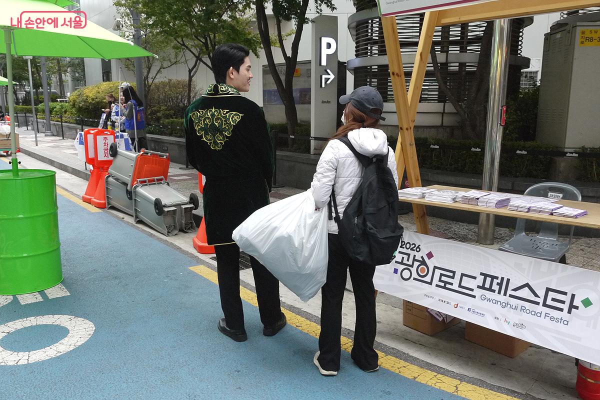미식 도시락 쿠폰을 받기 위해 전통의상을 입은 행사 진행요원과 게임을 하고 있는 방문객 &copy;최윤영