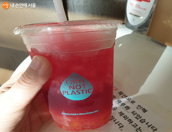 'I am NOT PLASTIC' 문구가 적힌 생분해성 소재 컵과 빨대를 사용한다. 